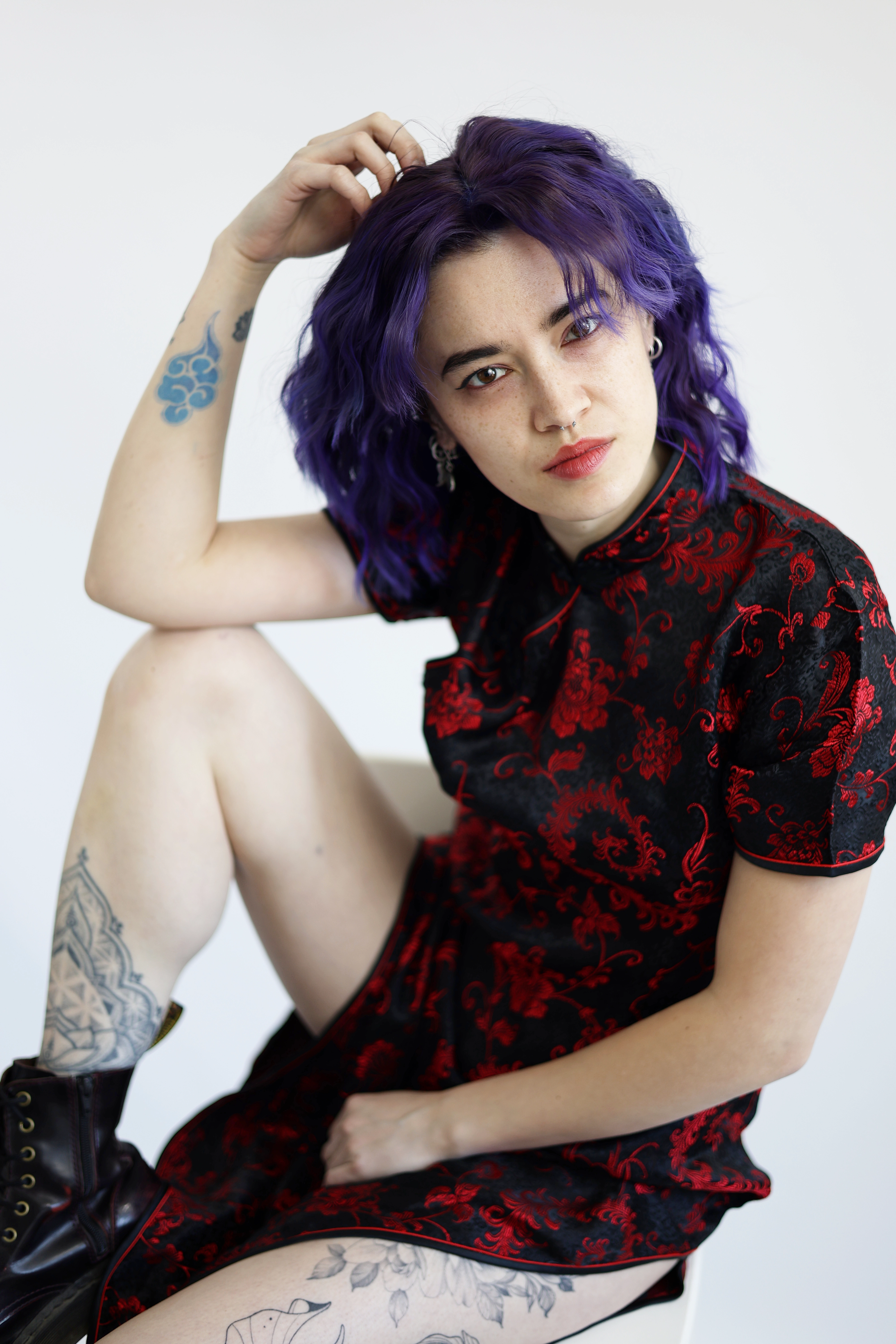 Portraot einer jungen Frau mit Tattoos und violetten haaren im chihnesischen Kleid